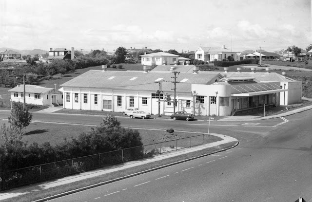 The Tauranga Dairy Factory at the corner of Eleventh Avenue and Devonport Road, Tauranga, photographed c.1969, with the harbour and Tauranga South visible in the distance.